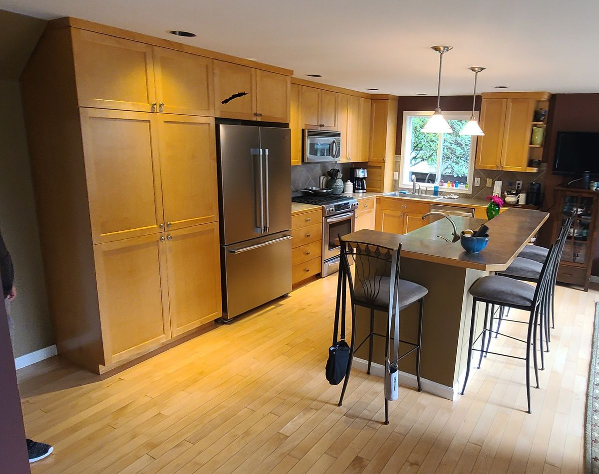 Kitchen before remodel - dated oak cabinets and old countertops
